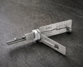 KW1 2-in-1 pick and decoder tool on stone surface