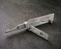 SC1 2-in-1 pick and decoder tool on stone surface